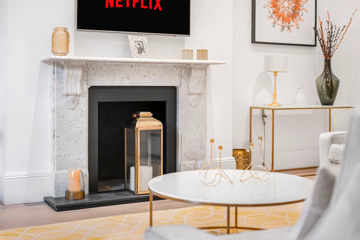 Ornate fireplace with carved details and a stylish mantel display