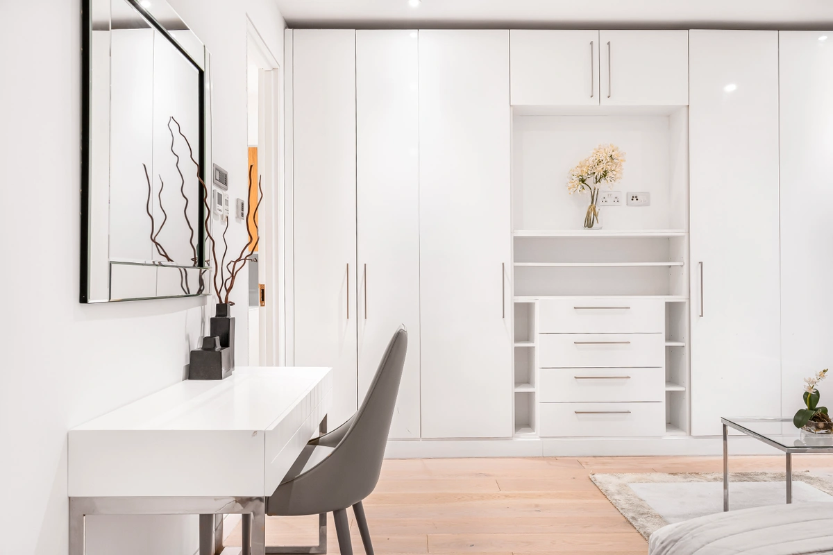 Home office space with desk, artwork, and natural light