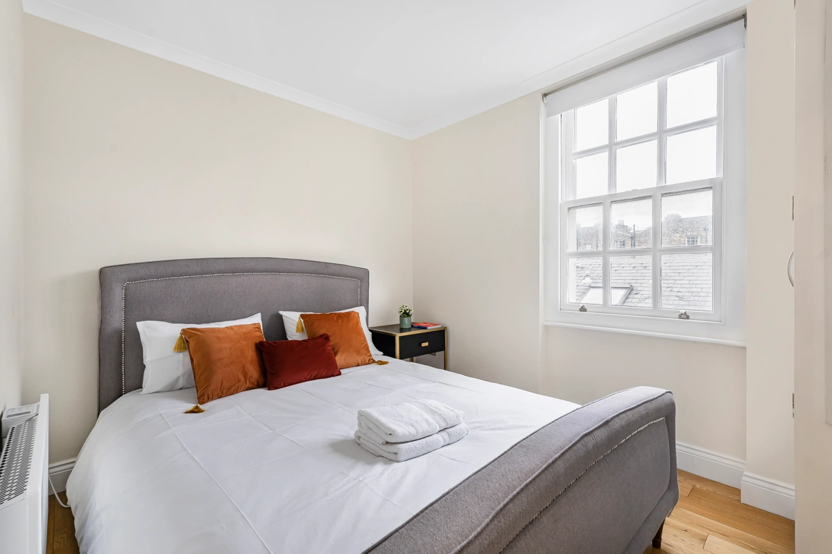 Cozy bed with plush linens and soothing colors for a restful stay