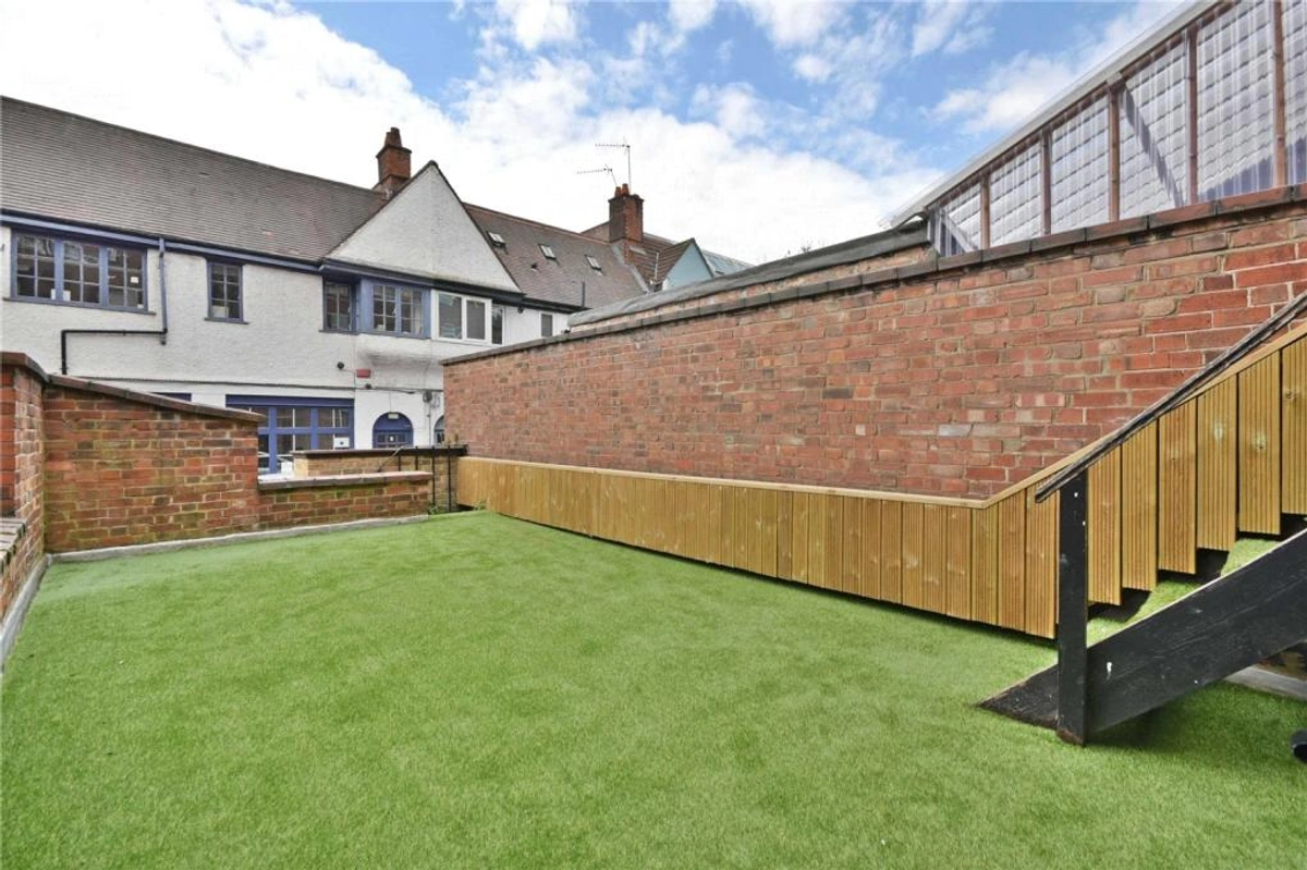 Private garden area with lush greenery and outdoor seating