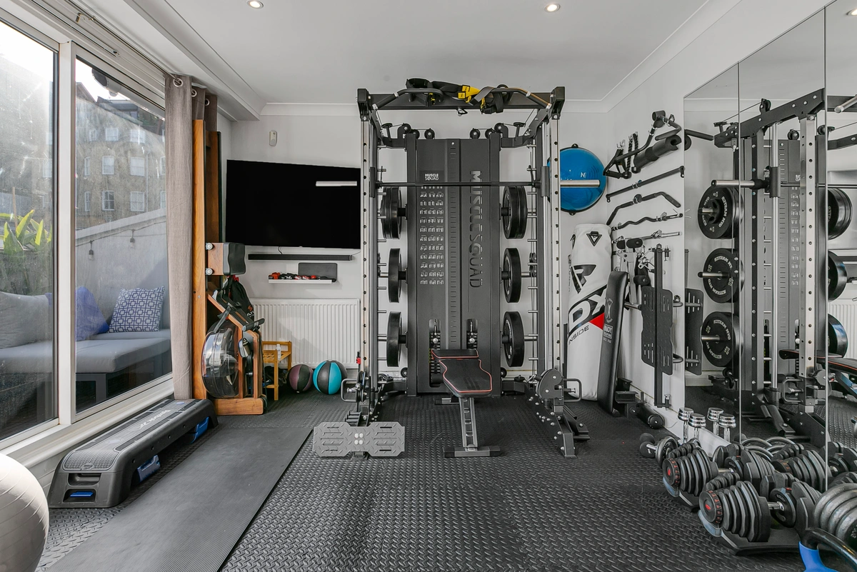Well-equipped home gym with cardio and strength training equipment