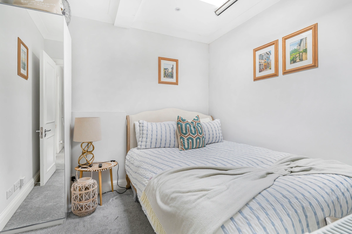 Comfortable bedroom with plush bed, soft linens, and calming decor