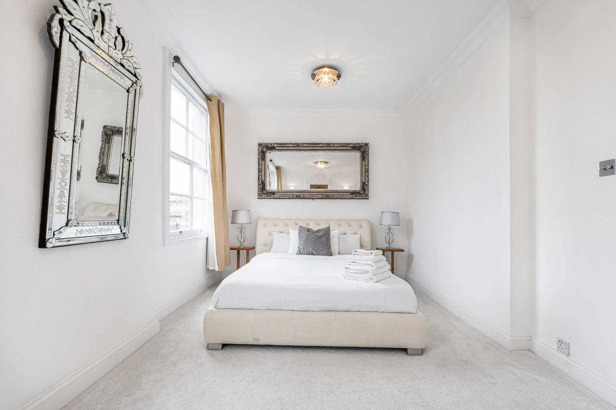 Spacious bedroom with large windows and modern decor