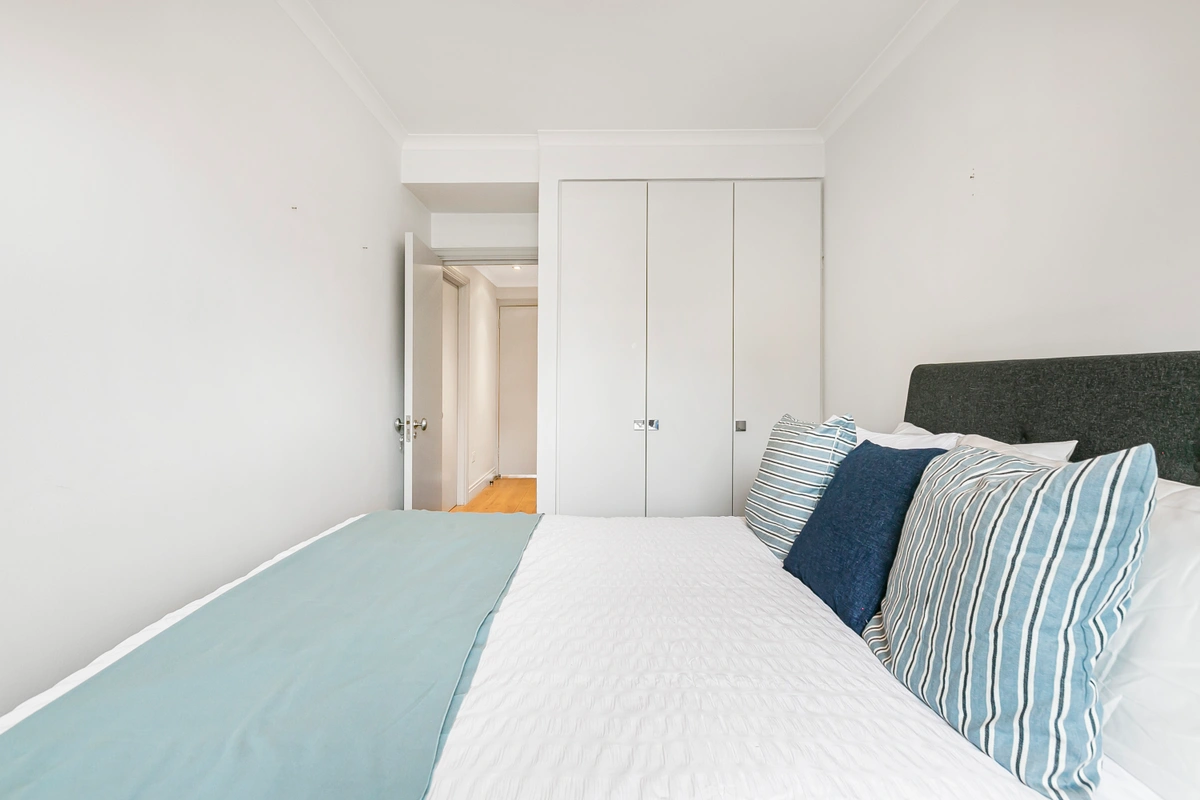 Bright bedroom with large windows and high-end decor