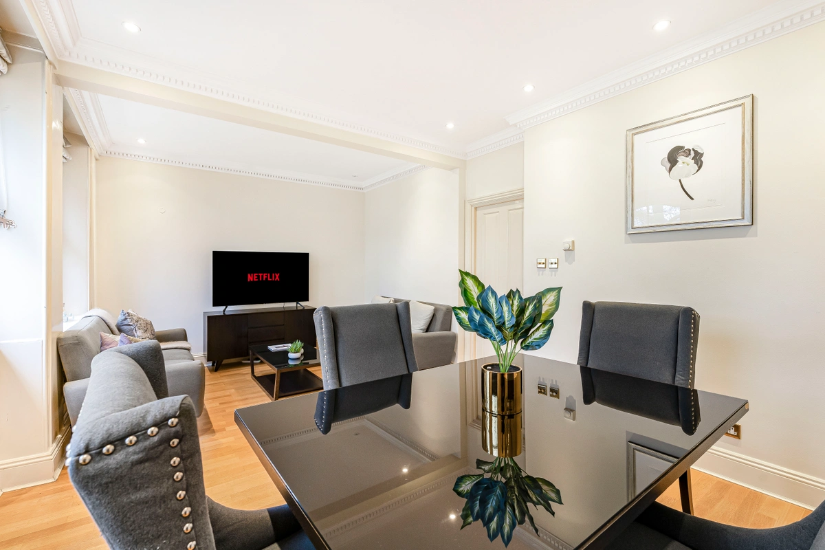 Wide-angle view of open-plan living and dining area with elegant touches