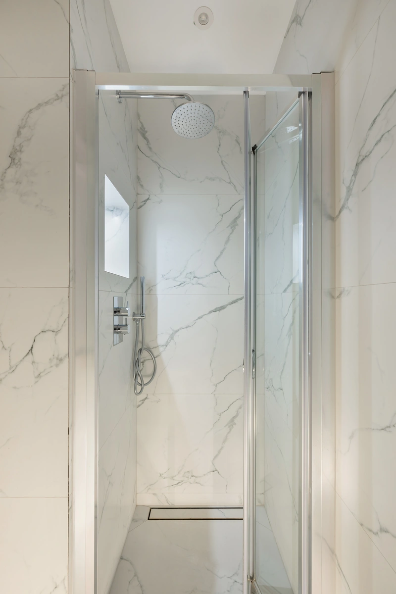 Spa-inspired bathroom with marble accents and rainfall shower