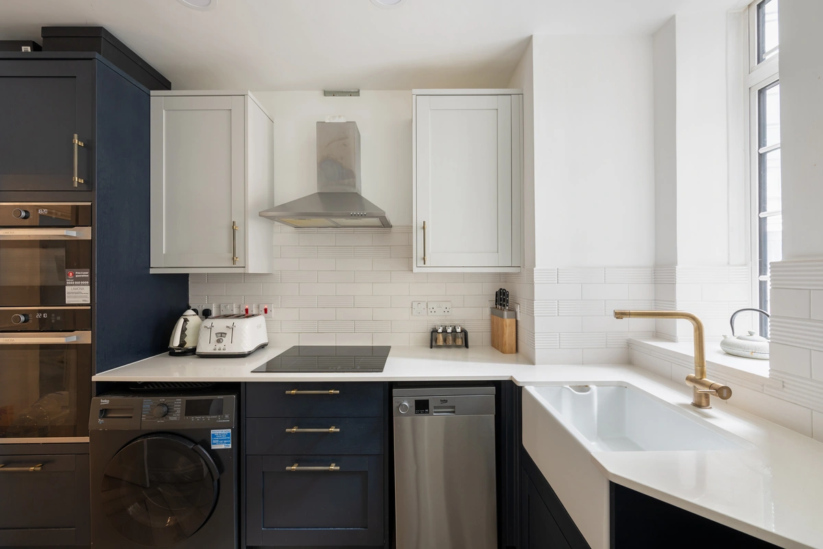 Fully equipped kitchen with bright finishes and ample counter space