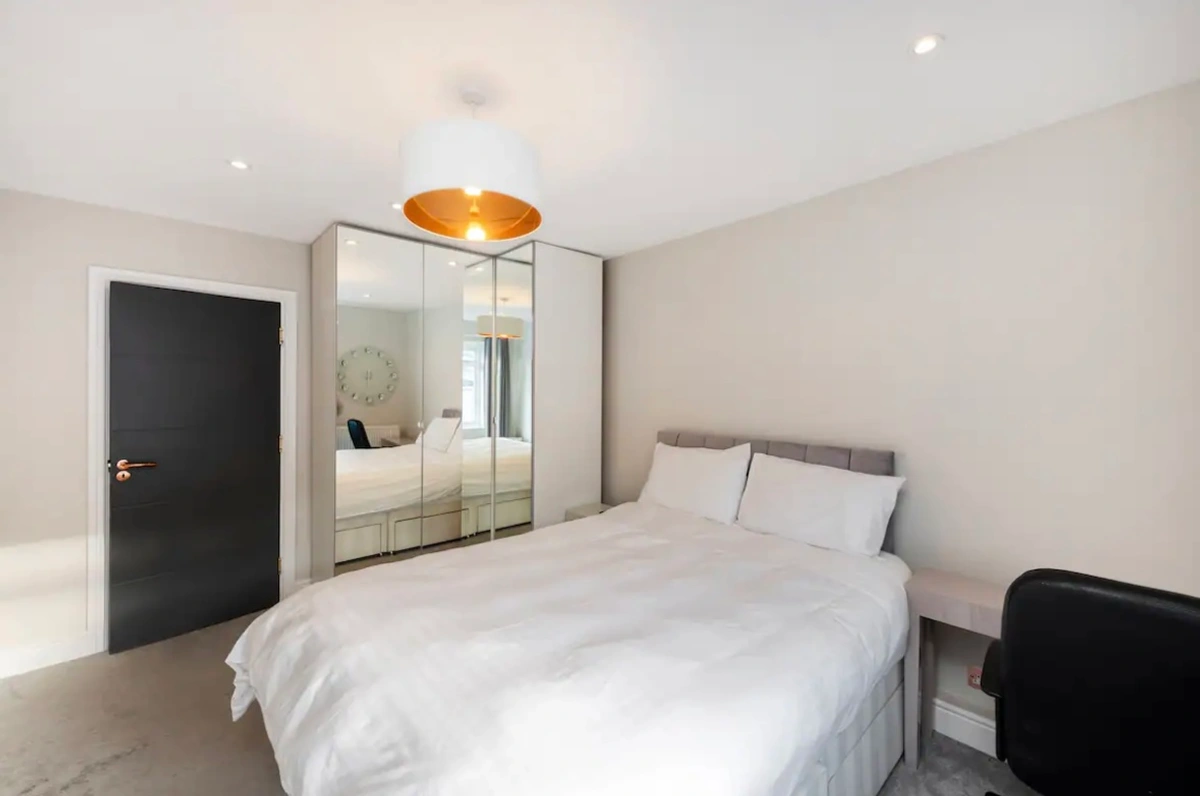 Bright bedroom with large windows and modern furniture