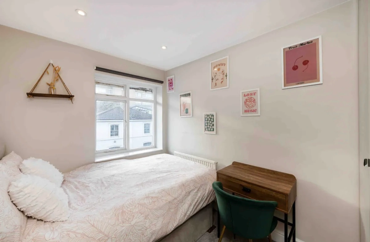 Second bedroom with cozy bed and tasteful design