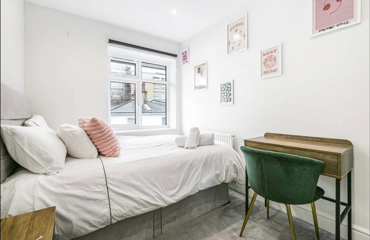 Serene bedroom with plush bedding and soft lighting