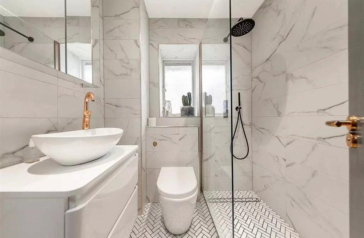 Contemporary bathroom with marble surfaces and refined fixtures
