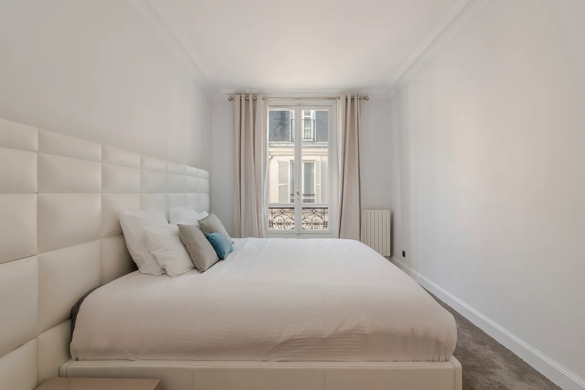 Sixth view of the sophisticated bedroom at Casa Cribs filled with natural light and refined furnishings.
