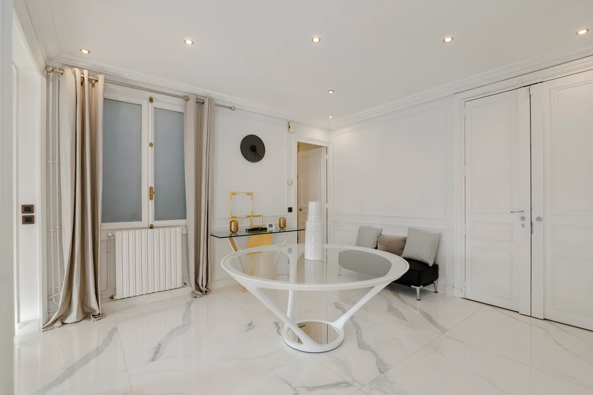 	Sleek glass dining table at Casa Cribs offering a modern and elegant touch.