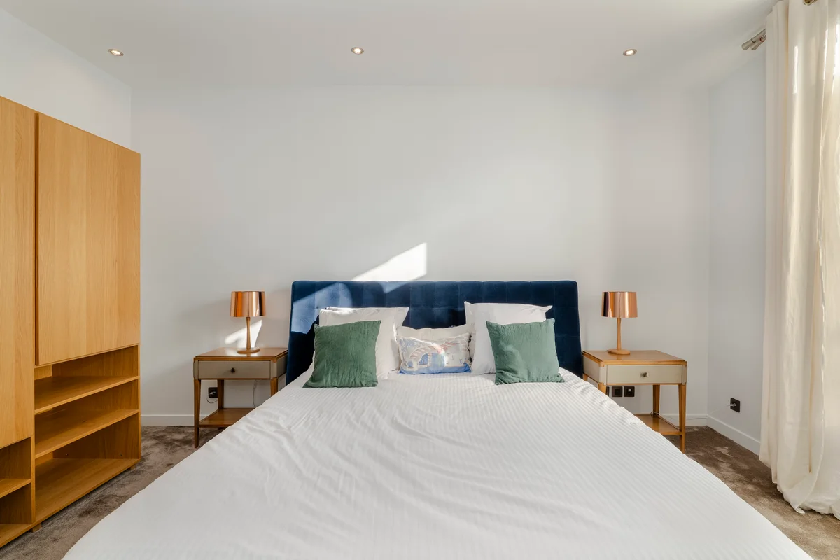 Second angle of the elegant bedroom at Casa Cribs filled with natural light and soft tones.