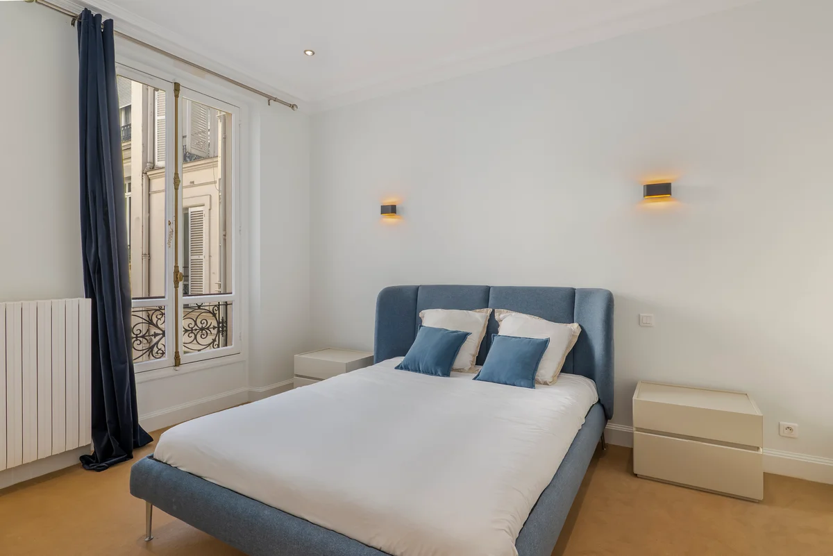 Third angle of the cozy bedroom at Casa Cribs with plush bedding and soft lighting.