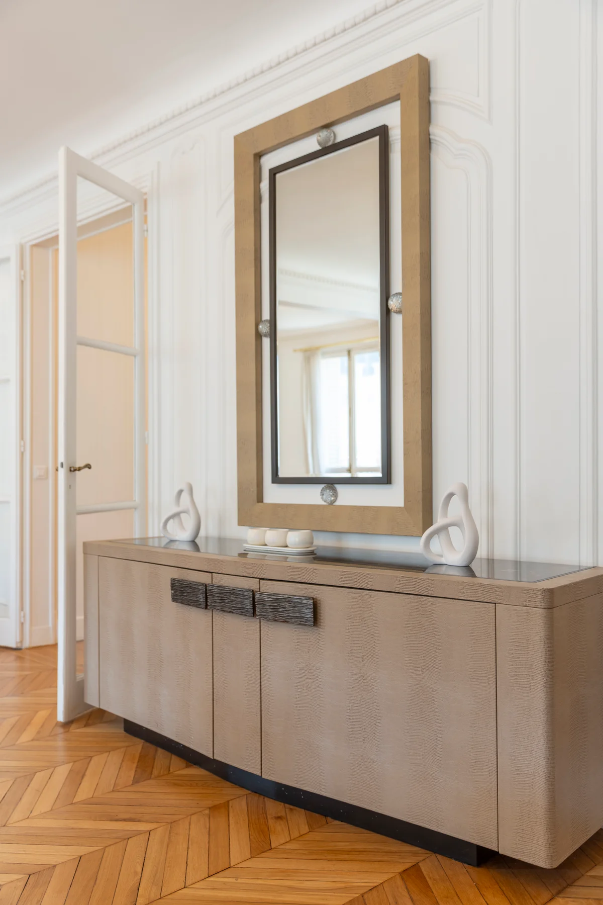 Decorative mirror and elegant sideboard at Casa Cribs adding a sophisticated touch to the space.