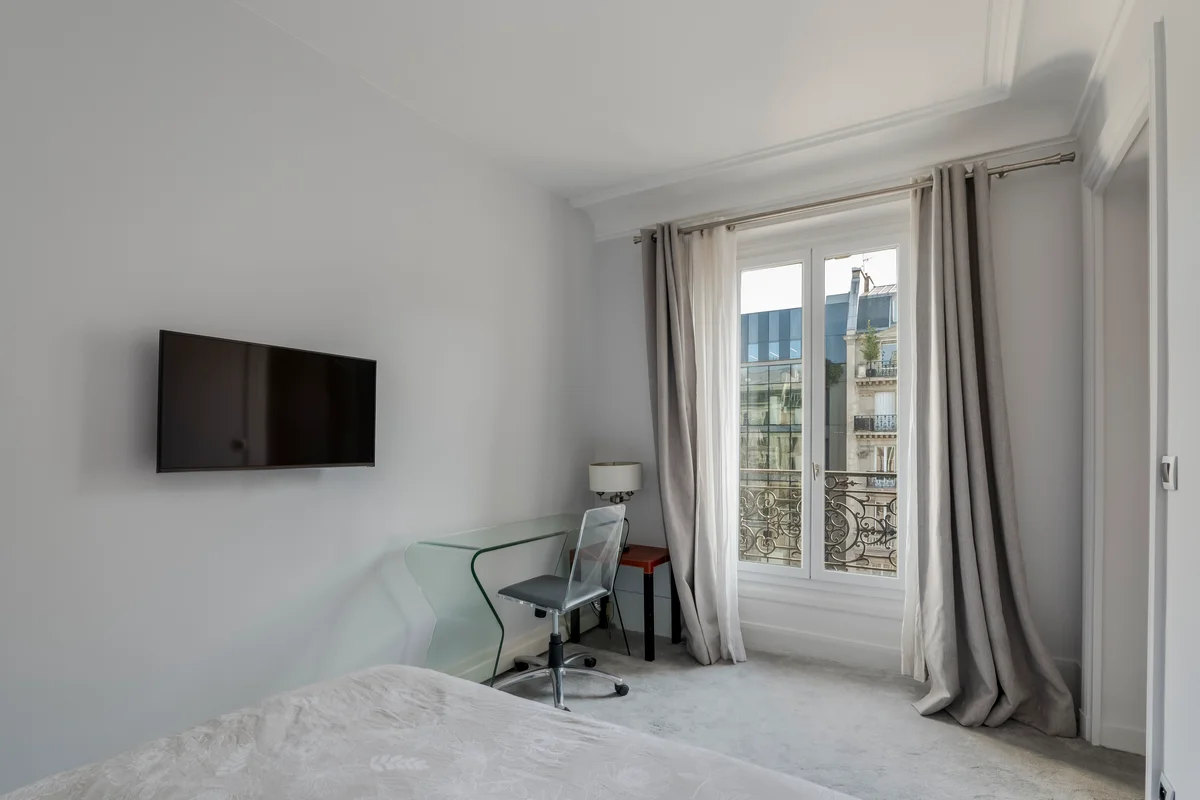 	Elegant bedroom at Casa Cribs featuring plush bedding, classic Parisian charm, and ample natural light.