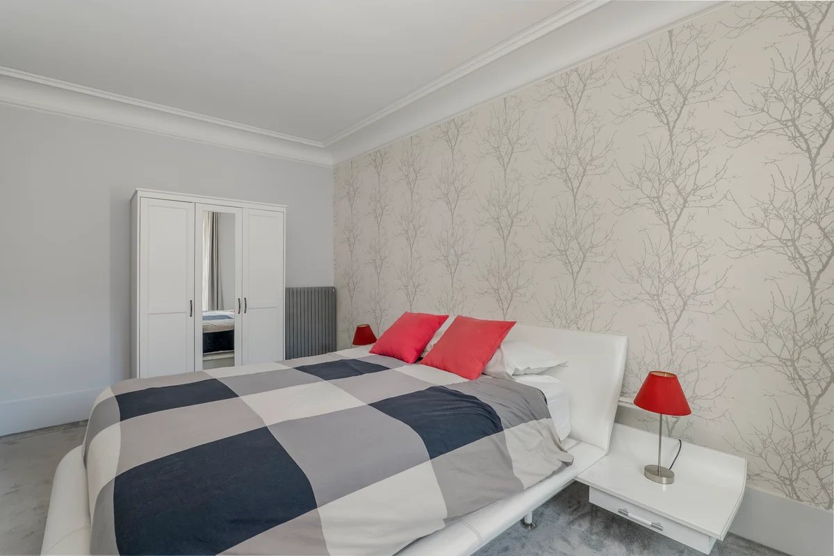 Another angle of the cozy bed at Casa Cribs with inviting bedding and sophisticated style.