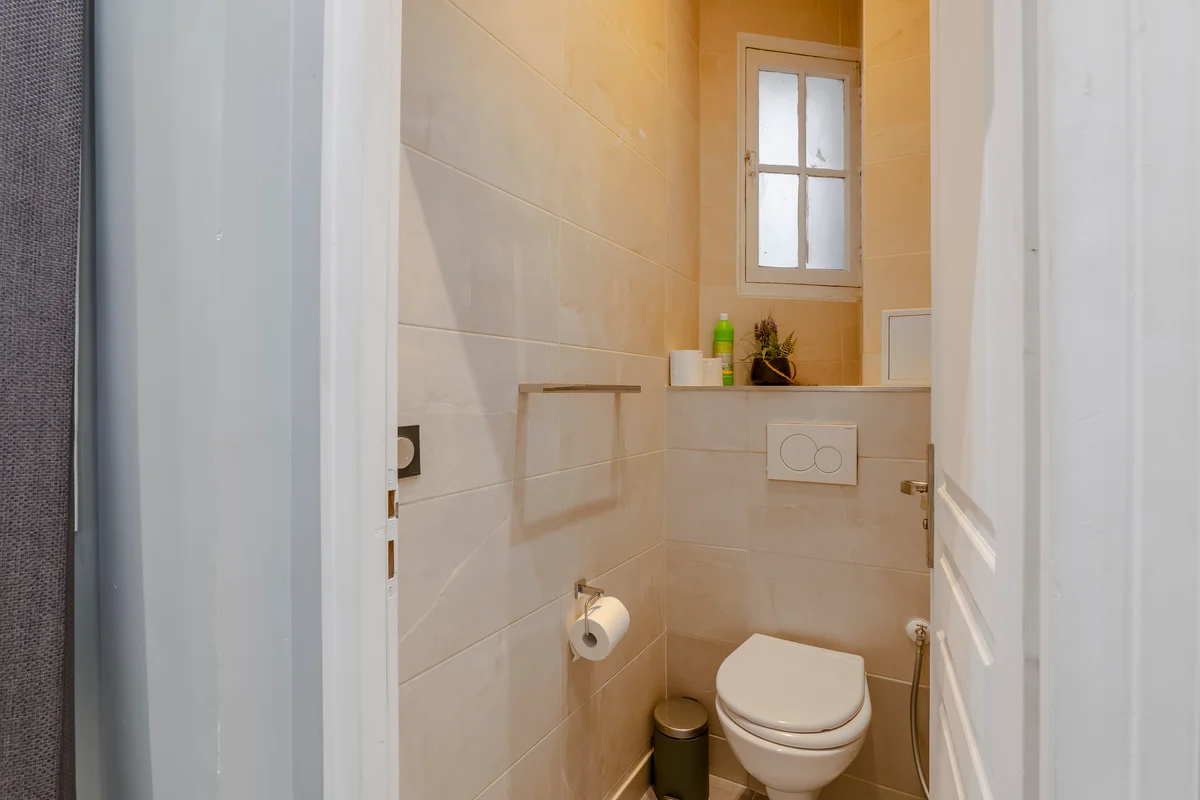 	Stylish guest restroom at Casa Cribs with modern fixtures and a chic design.