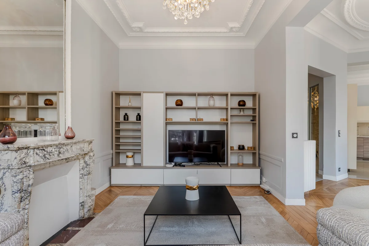 	Full view of the sophisticated living space at Casa Cribs with parquet floors and expansive windows.