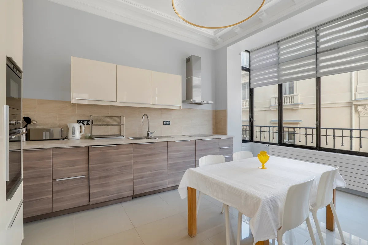	Another view of the stylish dining area at Casa Cribs with natural light and elegant decor.