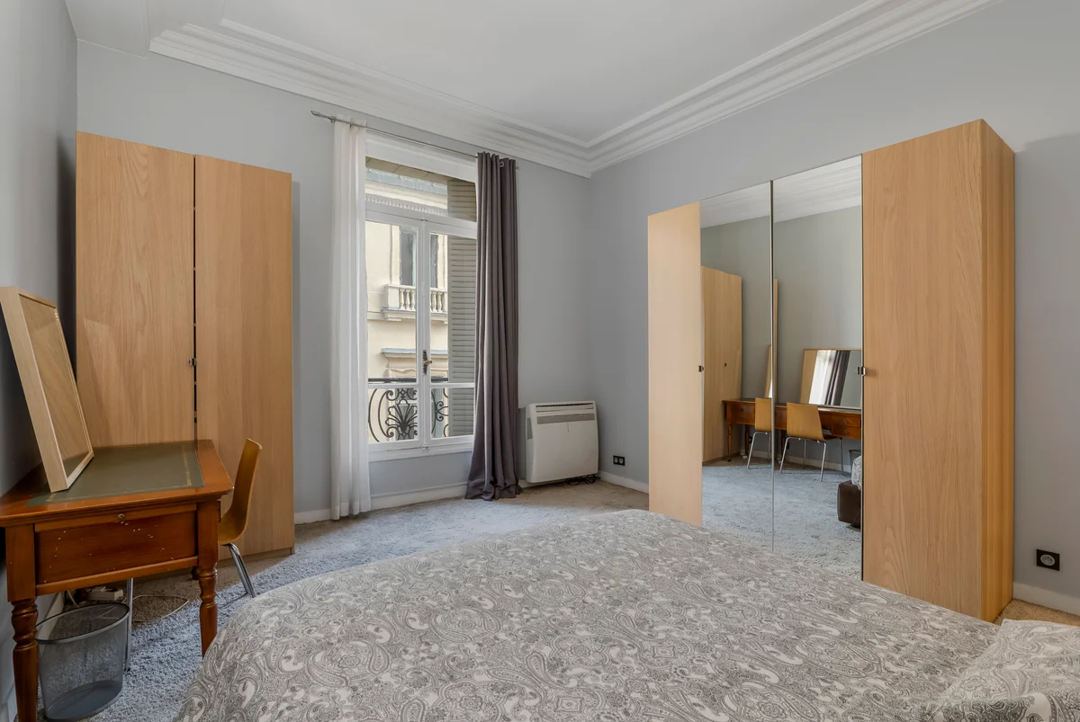 	Second view of the inviting guest bedroom at Casa Cribs with a plush bed and natural light.