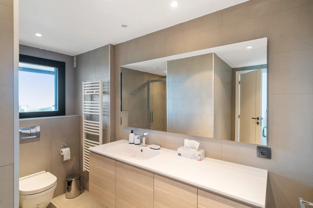 	Third view of the sleek bathroom at Casa Cribs with luxury finishes and natural light.