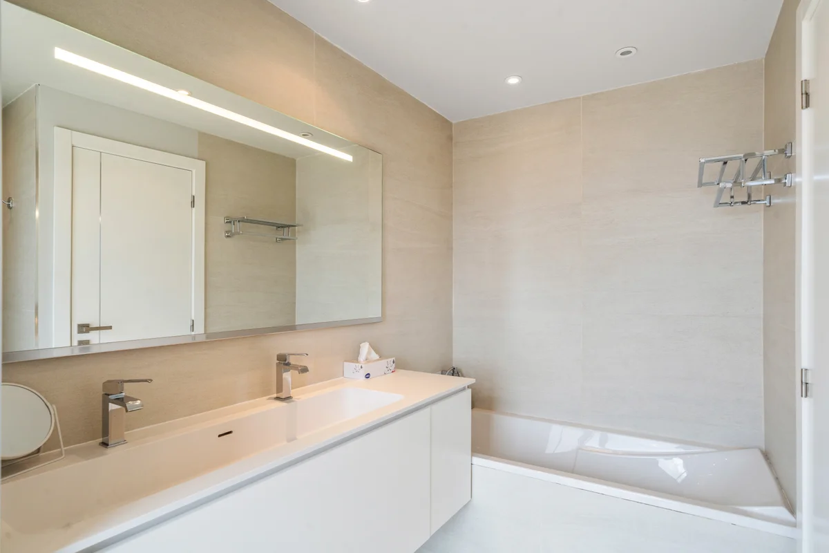 	Luxurious marble bathroom at Casa Cribs with a deep soaking bathtub and refined finishes.