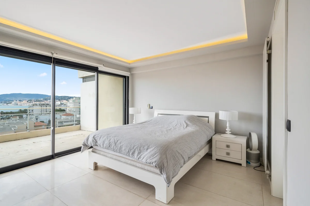 	Another view of the serene bedroom at Casa Cribs with refined details and sea-facing windows.