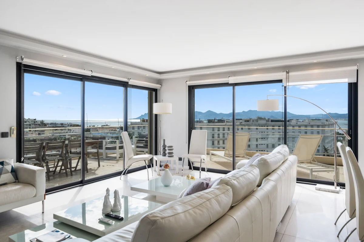 	Spacious living room at Casa Cribs with floor-to-ceiling windows and breathtaking sea views.