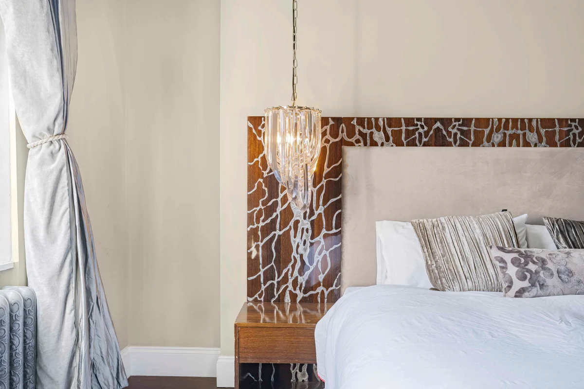 Another view of the elegant bedroom at Casa Cribs with large windows and natural light.