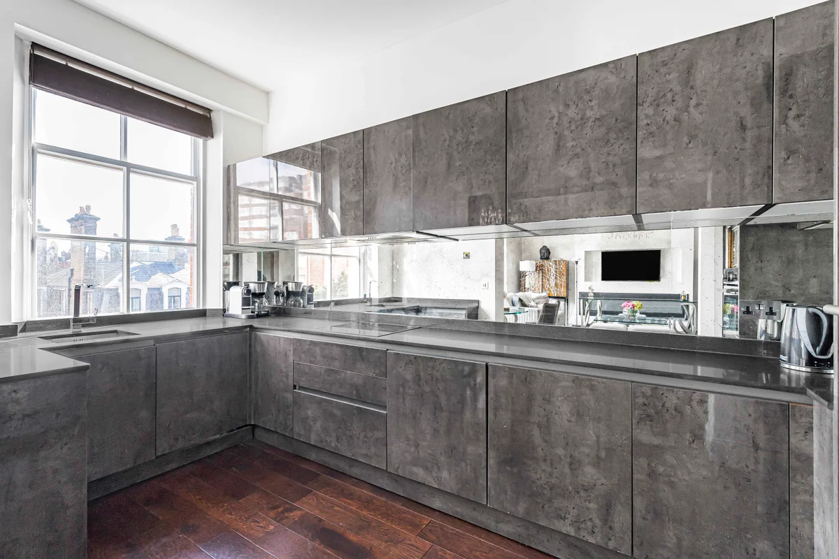 Fully equipped kitchen at Casa Cribs with modern appliances and marble accents.