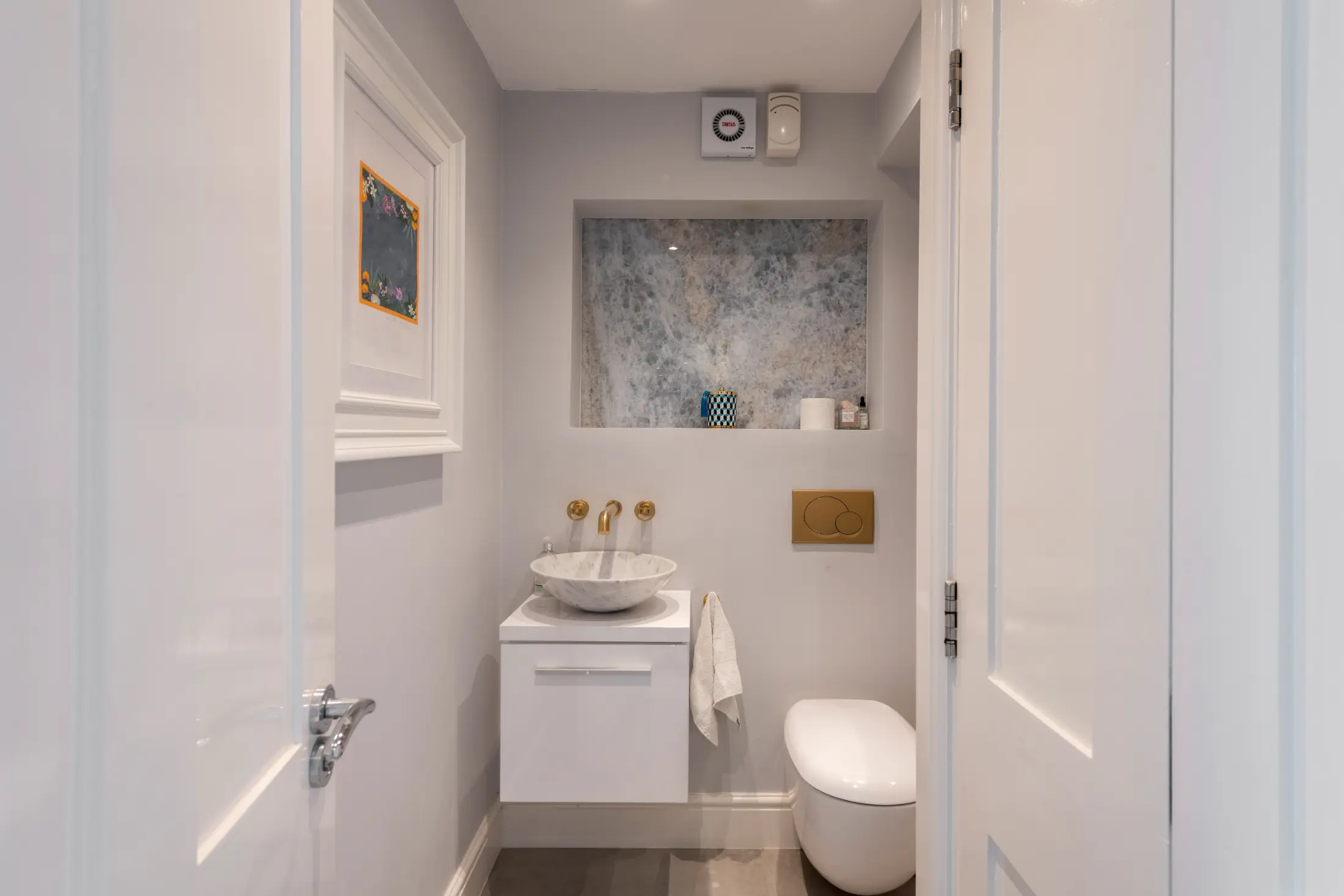 Third view of the elegant bathroom at Casa Cribs with marble finishes and modern amenities.
