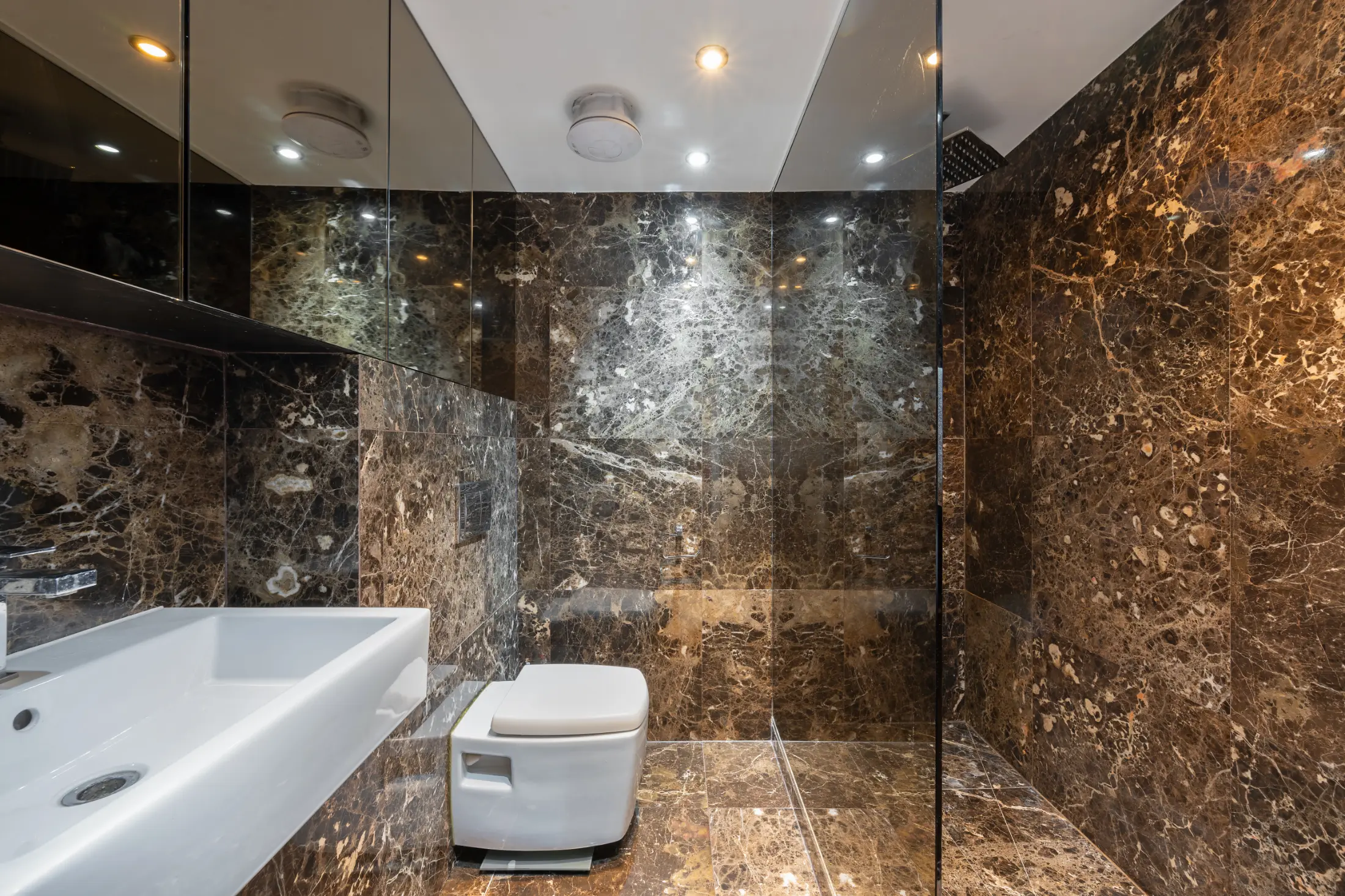 Modern bathroom at Casa Cribs with marble finishes and contemporary design.