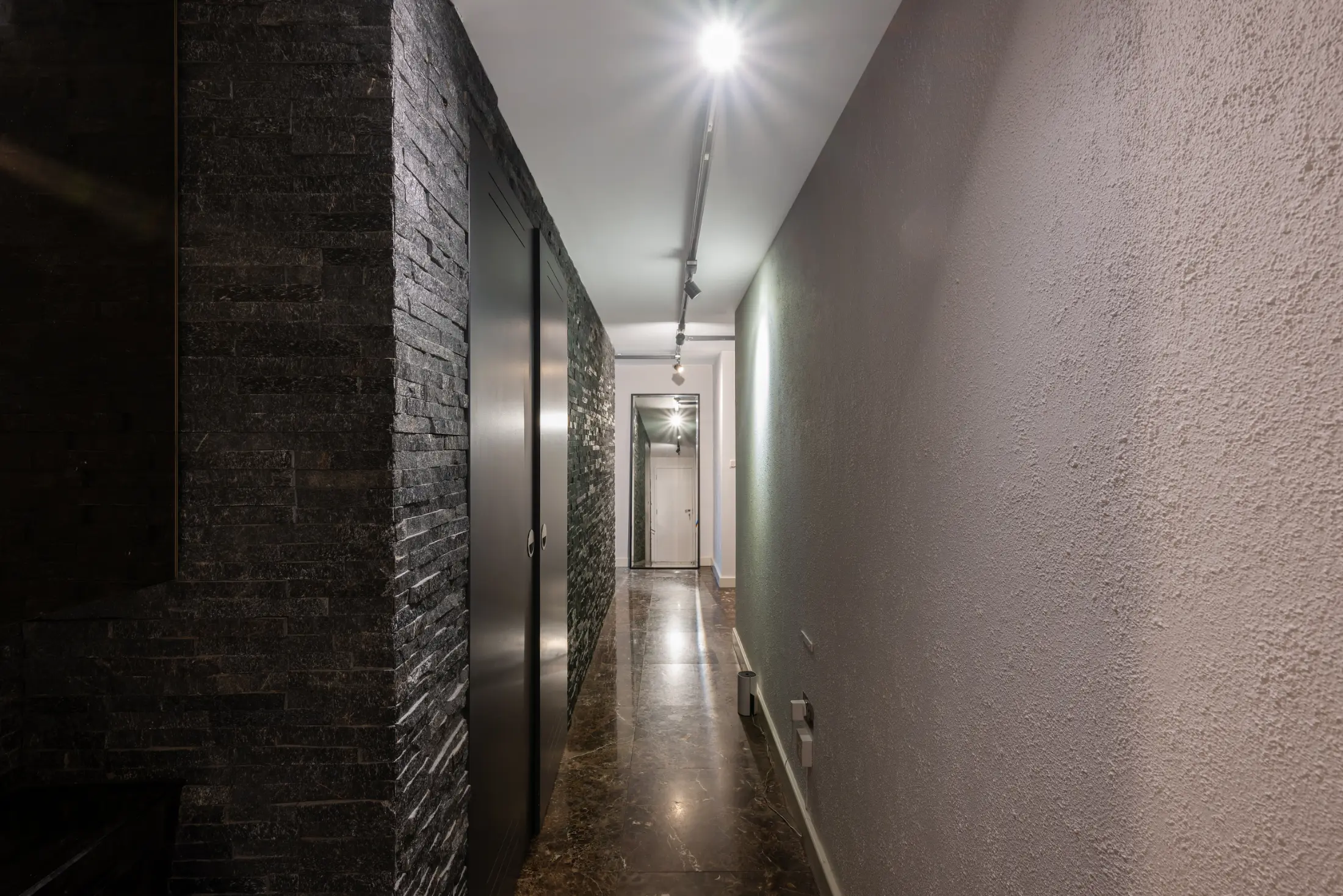 Bright hallway at Casa Cribs with refined finishes and modern touches connecting the living spaces.