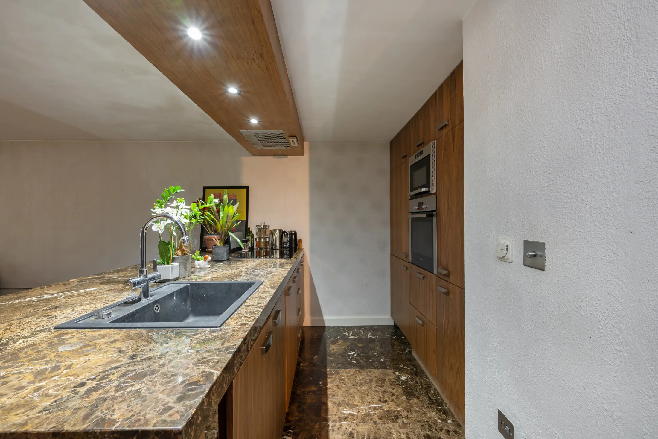 Another view of the modern kitchen at Casa Cribs with elegant cabinetry and ample space.