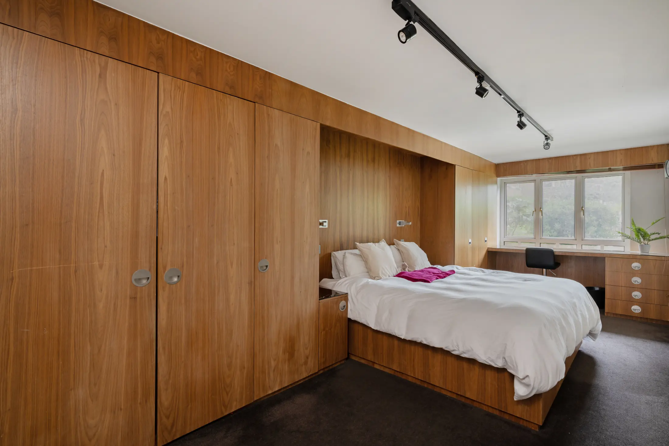 Second view of the bedroom at Casa Cribs with ample storage and cozy decor.