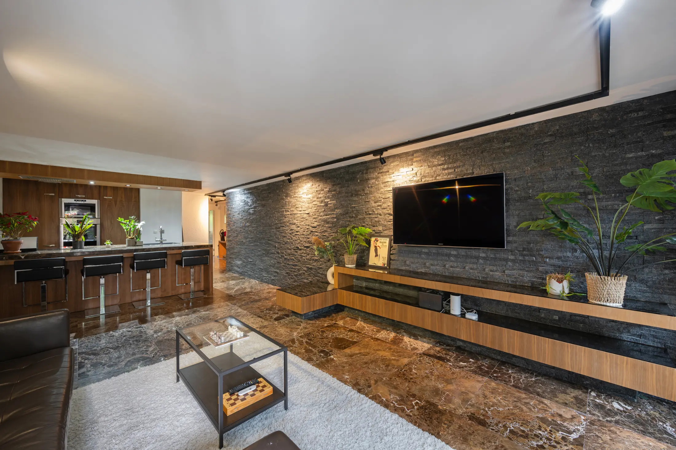 Third view of the living room at Casa Cribs featuring refined furnishings and natural light.