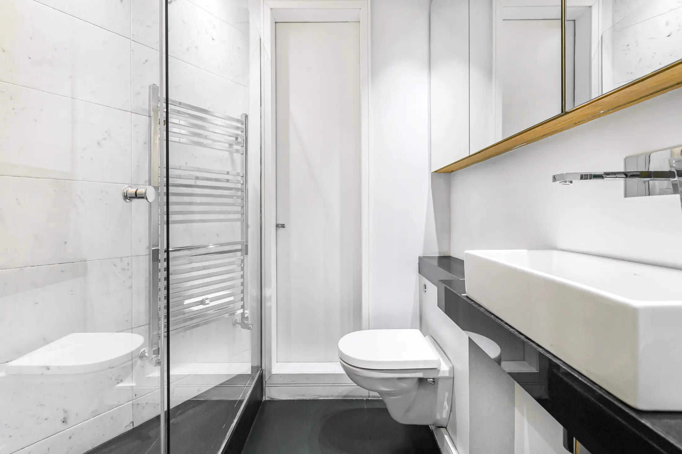 Modern bathroom at Casa Cribs with a rainfall shower and luxurious marble finishes.