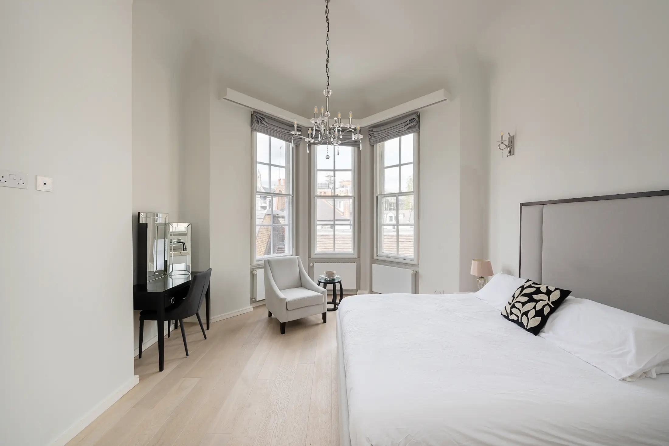 Third angle of the serene bedroom at Casa Cribs with plush bedding and warm lighting.