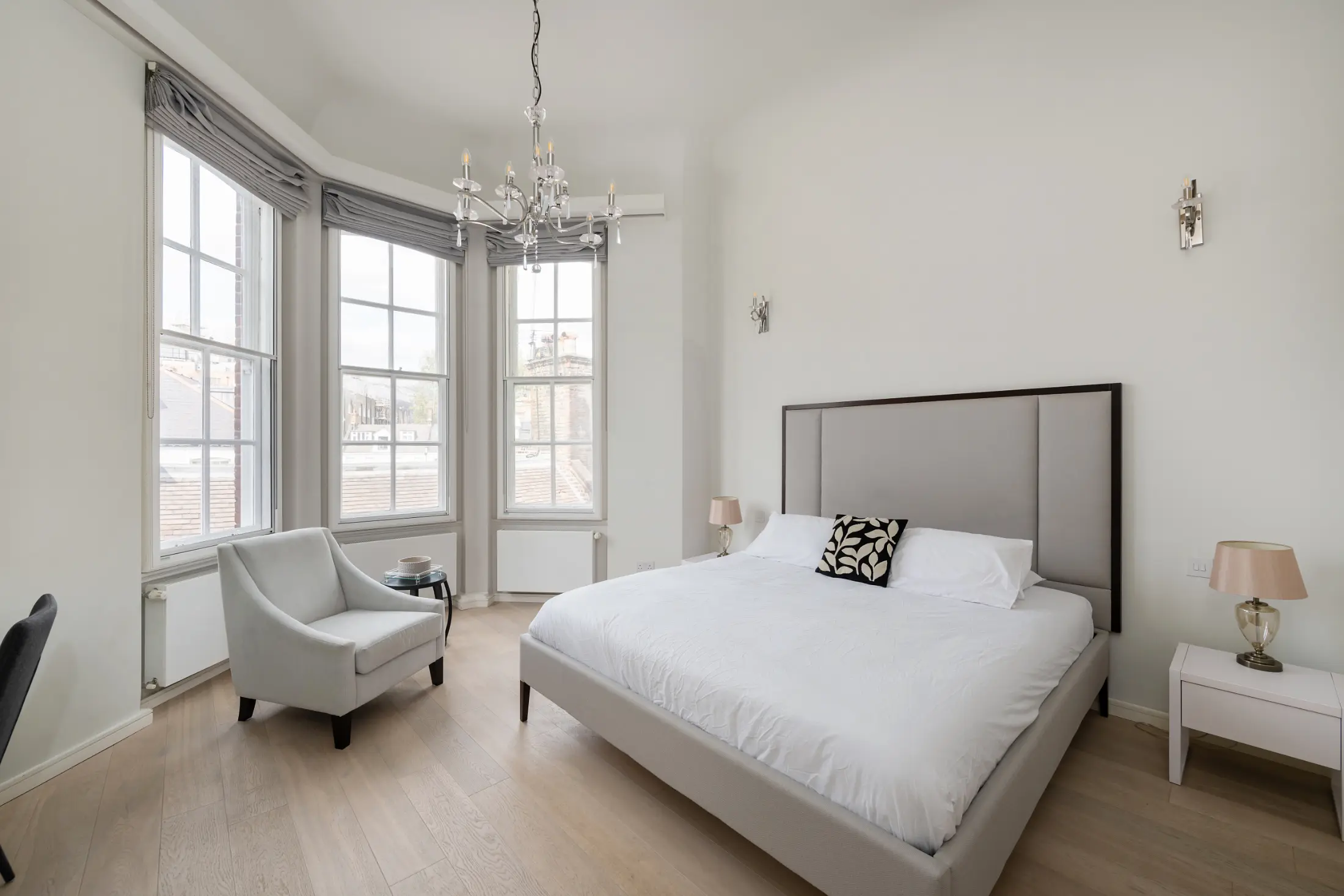 Second view of the elegant bedroom at Casa Cribs featuring refined furnishings and natural light.