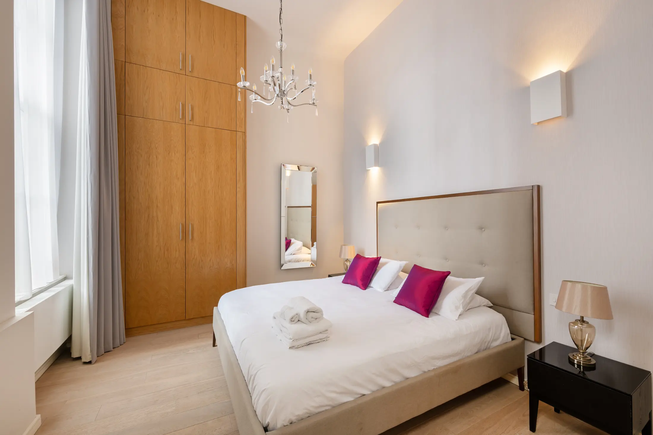 Spacious bedroom at Casa Cribs featuring plush bedding and sophisticated design.