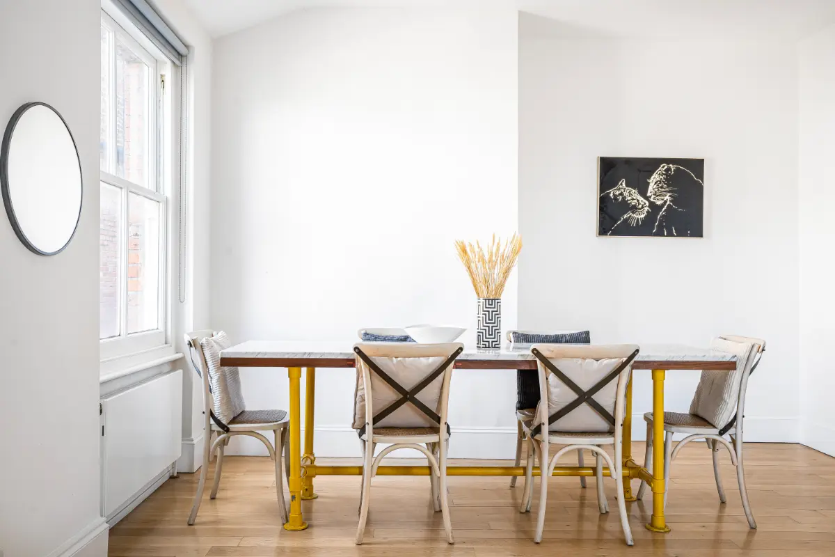 Another view of the dining area at Casa Cribs with a marble table and cozy ambiance.