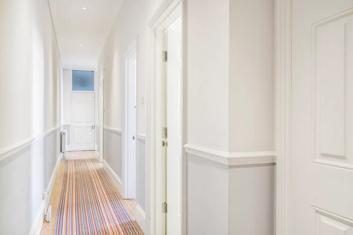 Stylish hallway at Casa Cribs with refined finishes and modern lighting.