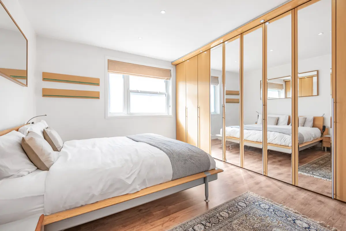 Another view of the elegant bedroom at Casa Cribs with large windows and natural light.