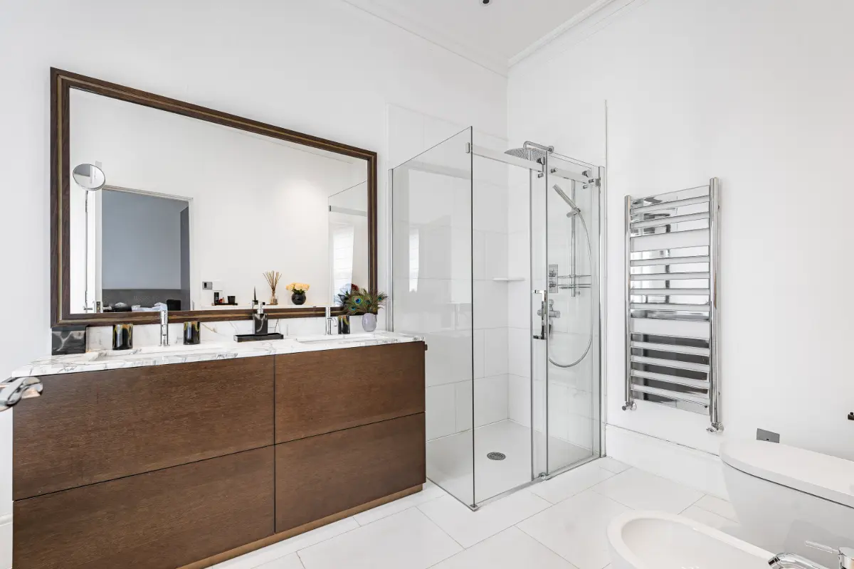 Sleek bathroom at Casa Cribs with contemporary fixtures and a spacious shower.