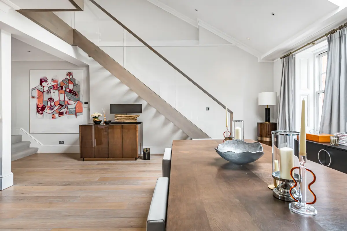 Stylish living space at Casa Cribs featuring a statement staircase and contemporary design.