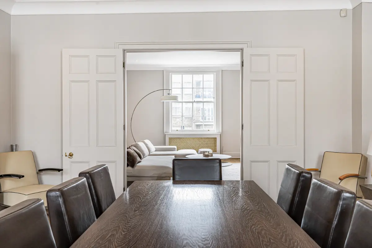 Dining table at Casa Cribs with seating for ten and warm lighting.