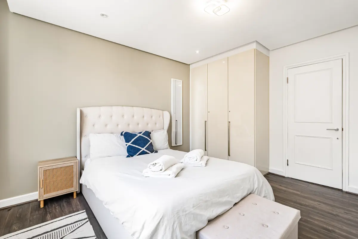 	Peaceful bedroom at Casa Cribs featuring a king-sized bed with plush linens and elegant decor.