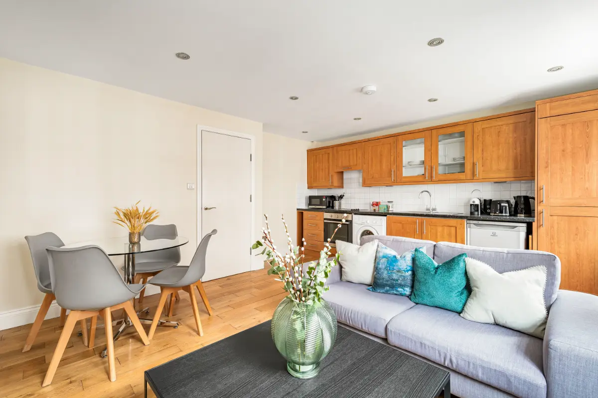 Open view of the living room, dining area, and kitchen at Casa Cribs.